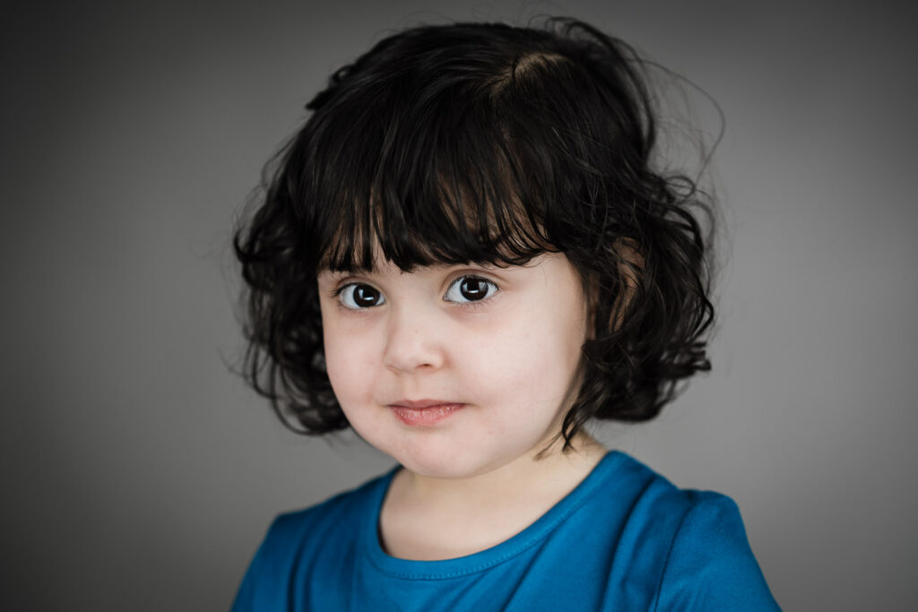 Child actor headshots NJ toddler calm direct gaze blue t-shirt gray background