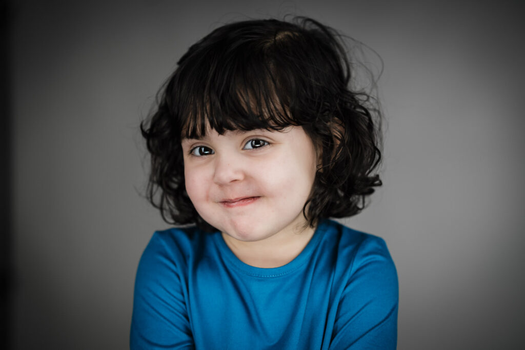 Child actor headshots NJ toddler mischievous smile blue shirt casting photographer