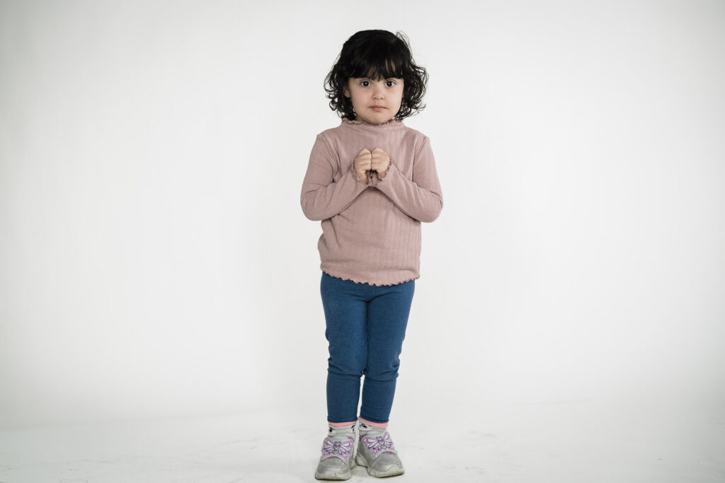 Child actor headshots NJ toddler full length pink turtleneck blue leggings white background