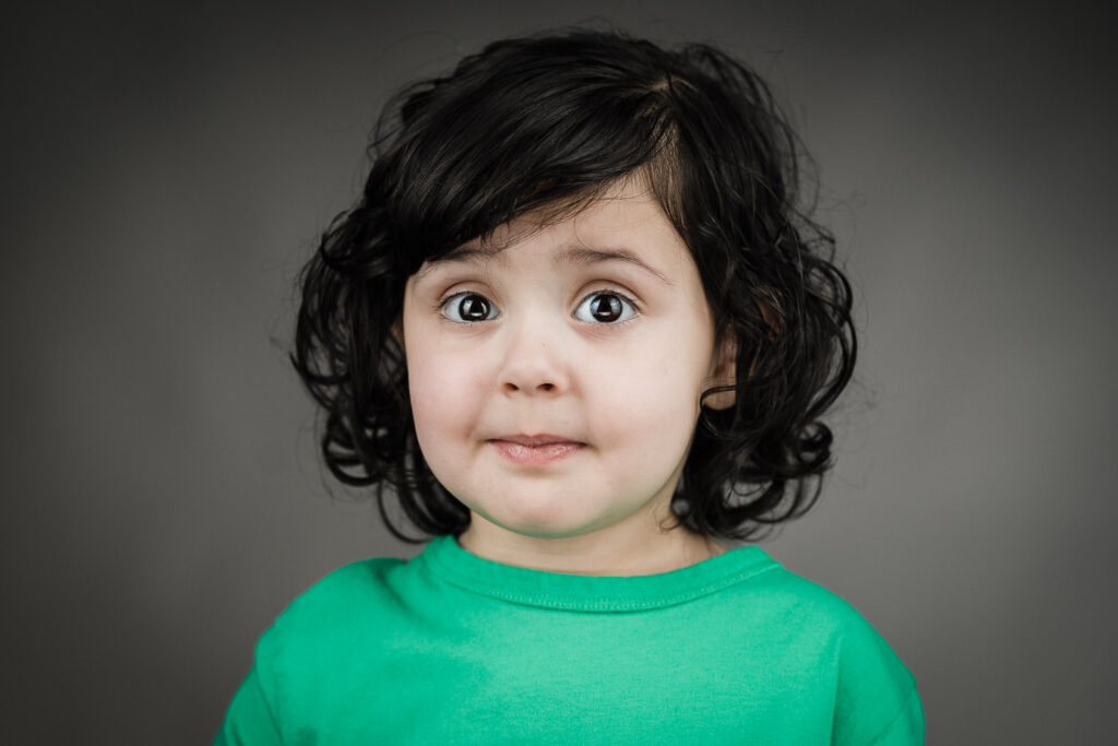 Child actor headshots NJ toddler wide-eyed expression green shirt casting