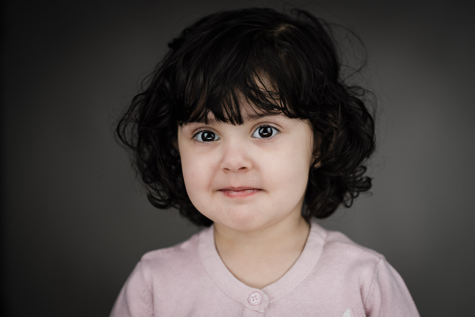 Child actor headshots NJ toddler gentle smile pink cardigan Northern New Jersey