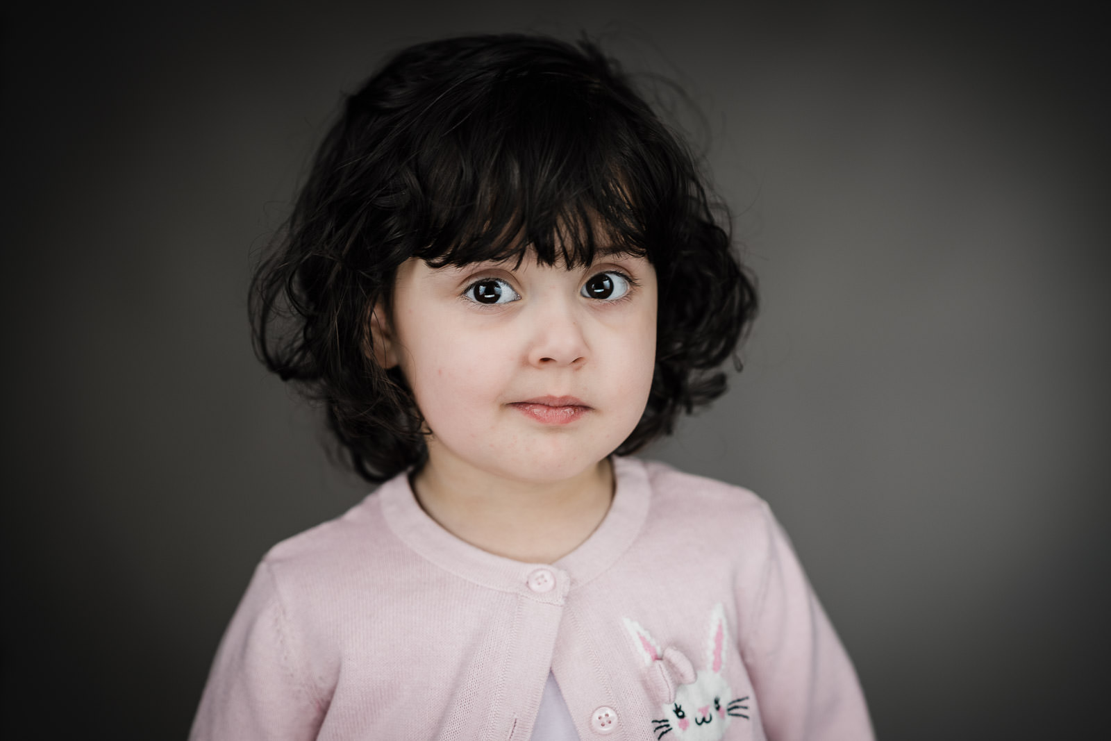 Child actor headshots NJ toddler pink cardigan neutral expression gray background
