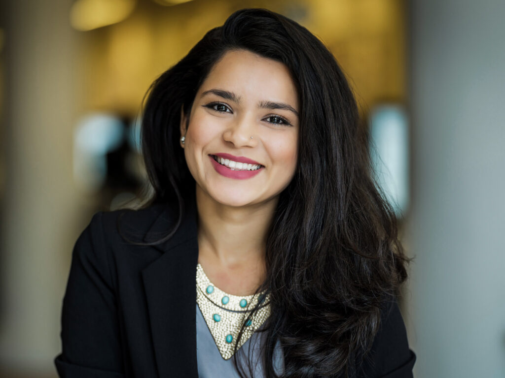 Confident executive wearing navy blazer in professional corporate headshot with natural expression
