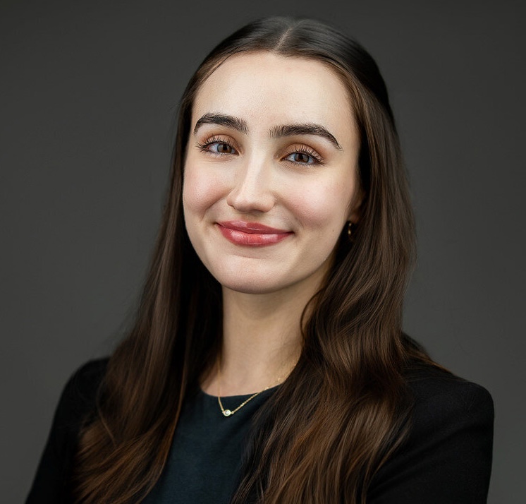 Graduate school application headshot of young woman in black blazer on dark studio background — New Milford NJ
