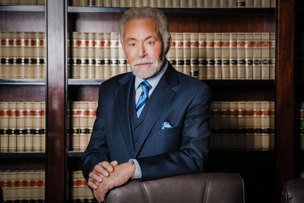 Senior partner attorney professional portrait seated in law library Bergen County New Jersey