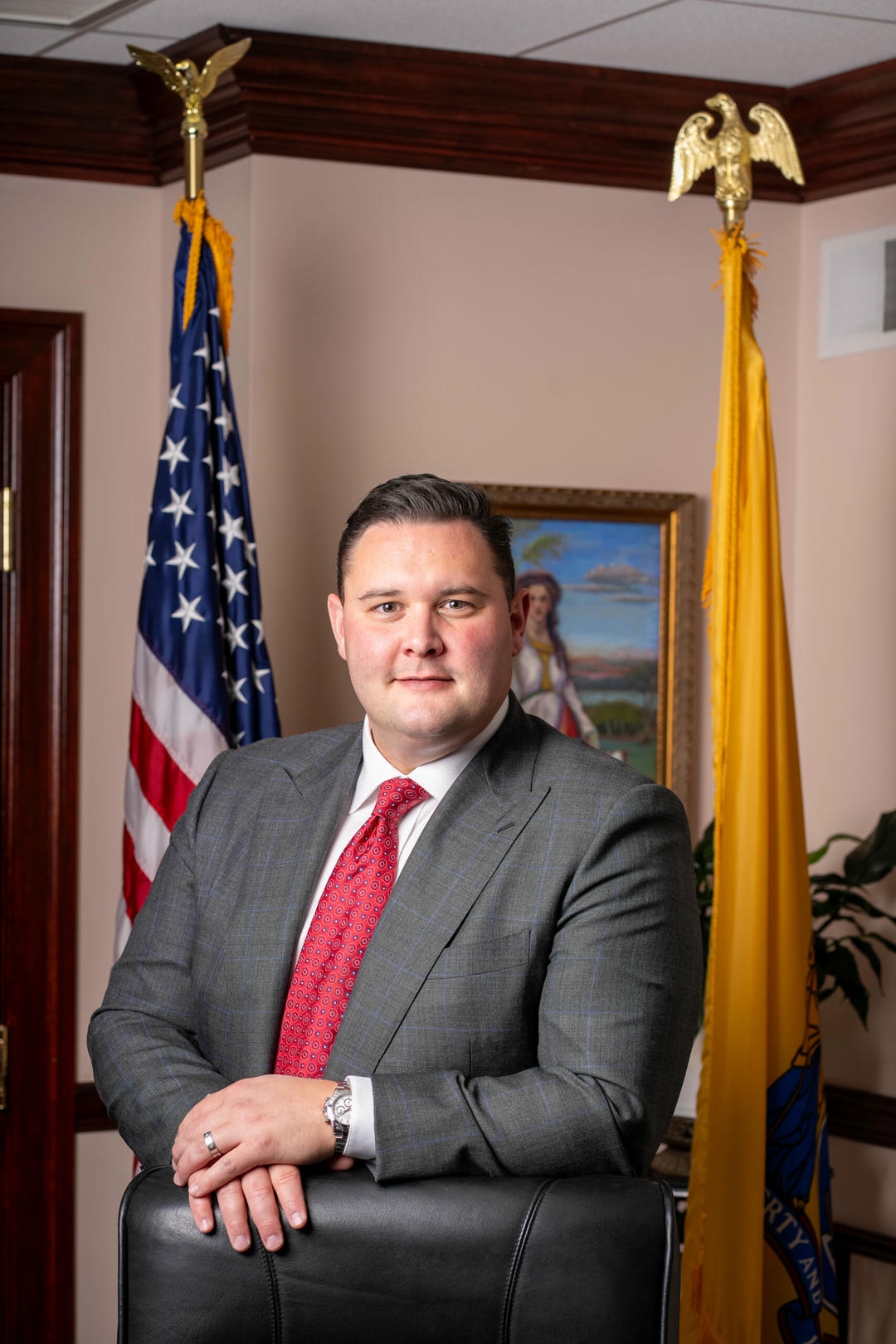 young attorney headshot smiling professional blue tie bergen county