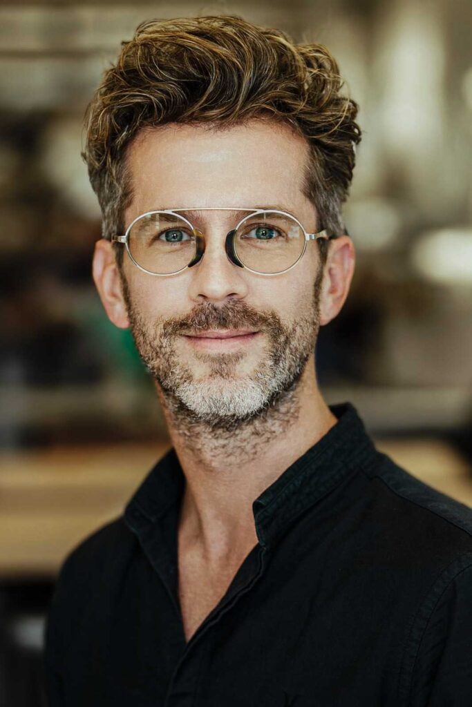 Man in glasses and black shirt photographed during personal branding session in New Jersey