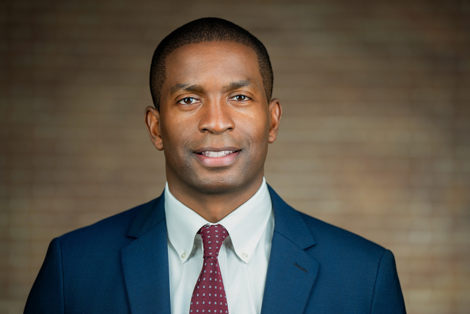 Professional headshot of man in navy suit burgundy tie Parsippany NJ corporate session