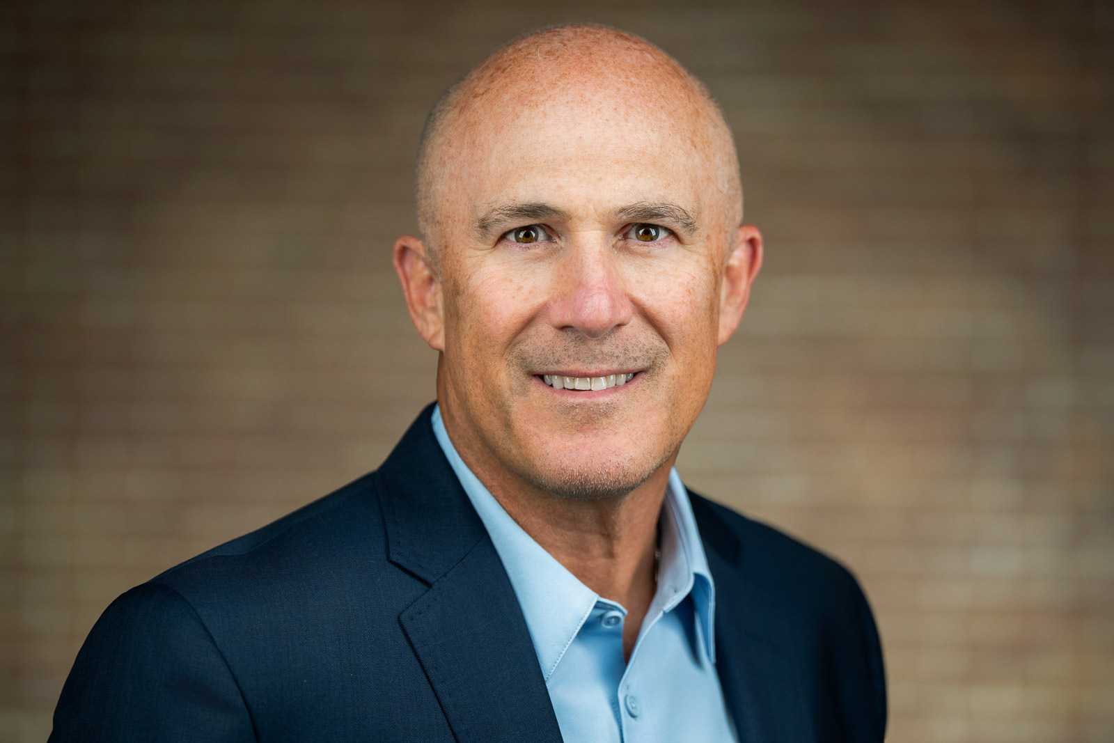 headshot of senior man in navy blazer light blue open-collar shirt NJ team