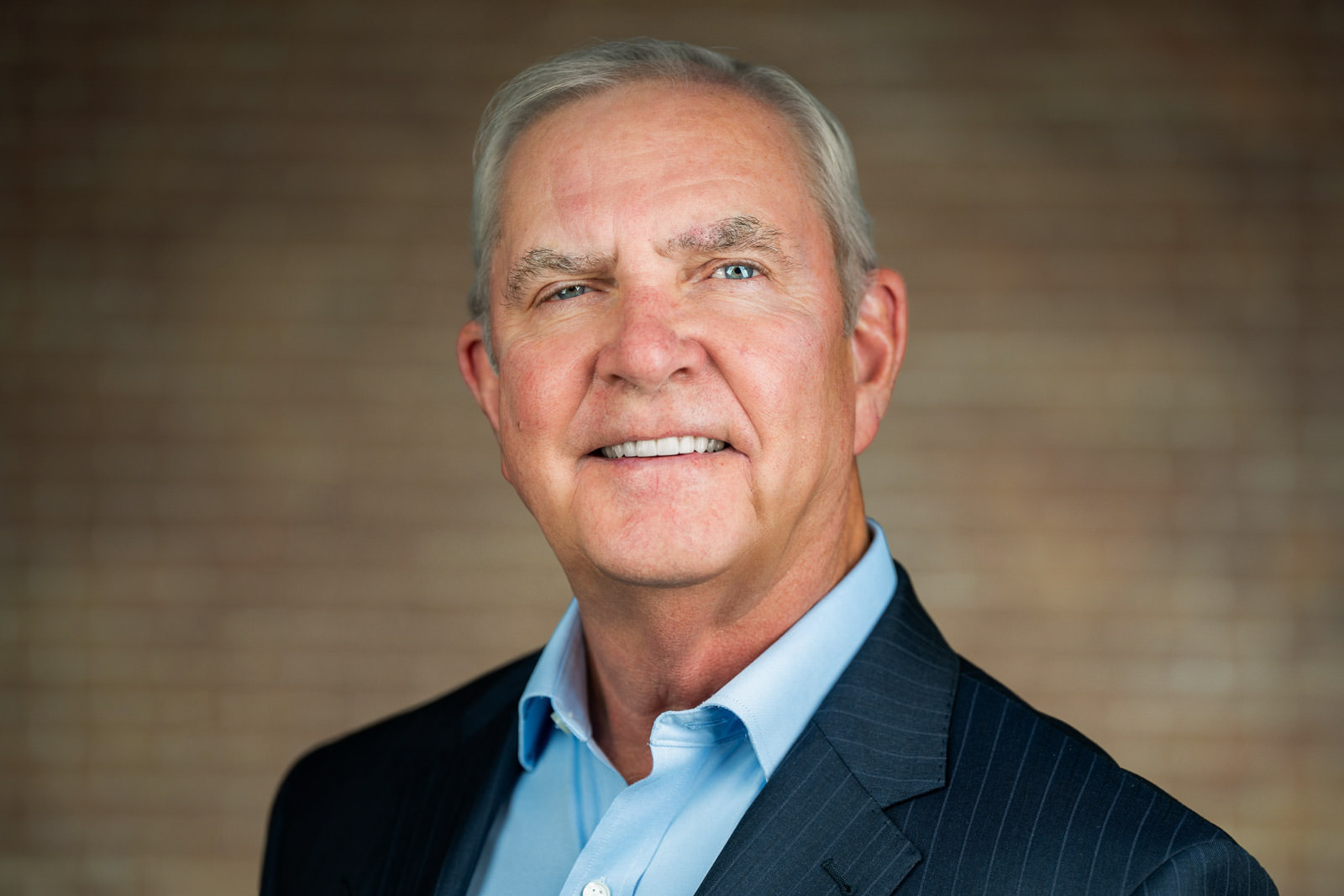 Executive corporate headshot of senior man in dark pinstripe suit Parsippany NJ