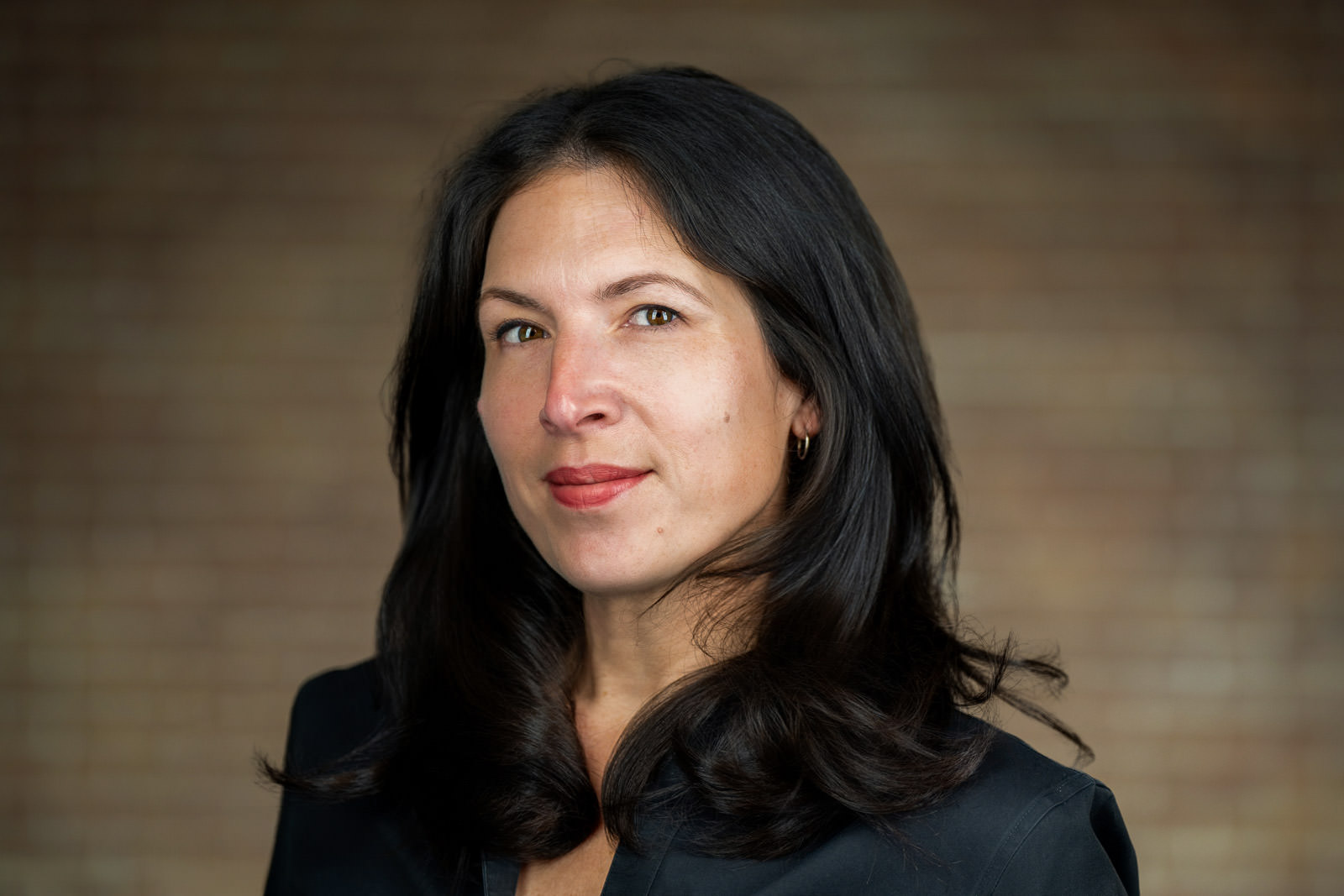 Professional corporate headshot of woman in dark blazer for NJ financial services firm