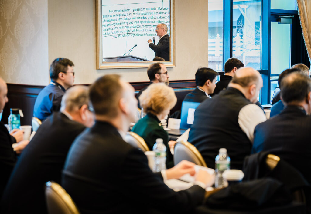 Audience of professionals listening to keynote presenter at a corporate retreat photographed in New Jersey