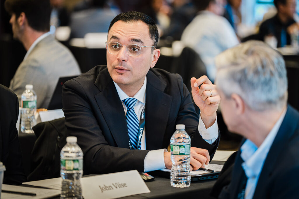 Executive professional in conversation at a corporate retreat in New Jersey captured in a candid documentary style