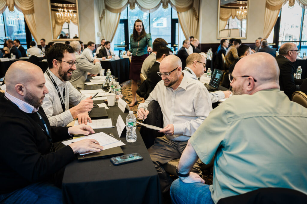 Large group of business professionals working through a breakout activity at a corporate retreat in NJ