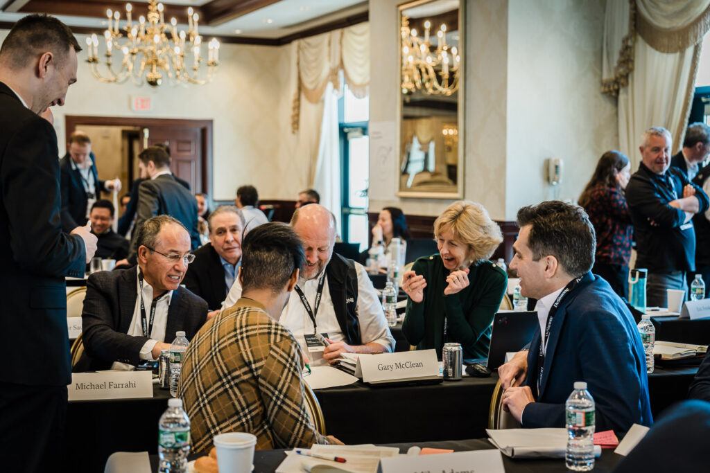Business professionals in conversation during a networking break at a corporate retreat photographed in New Jersey