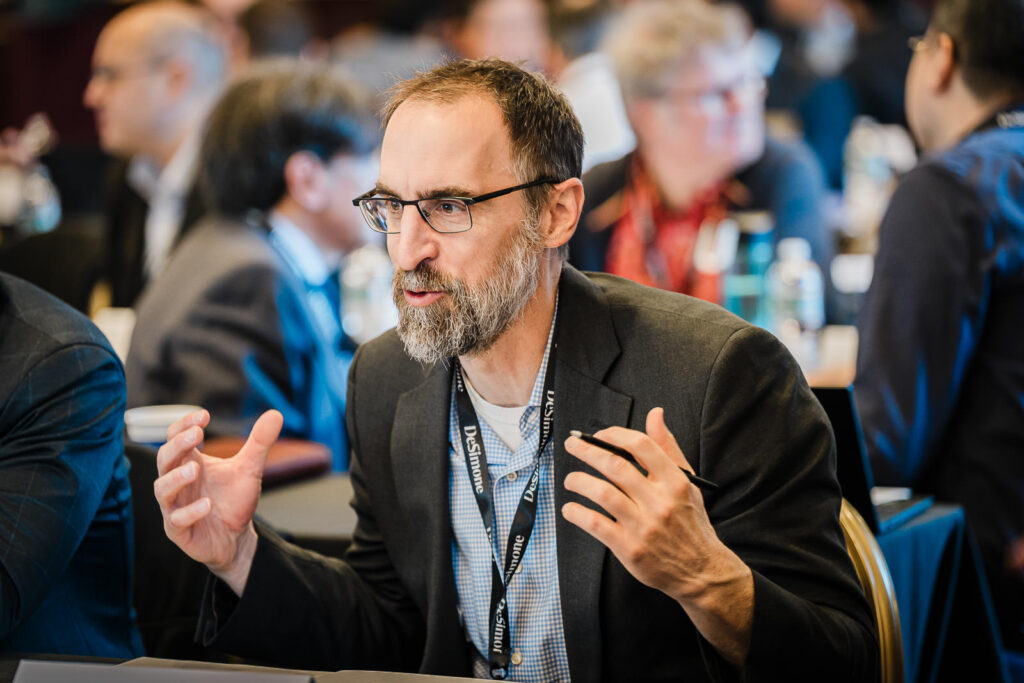 Business professional making a point with hands during a small group discussion at a corporate offsite in NJ
