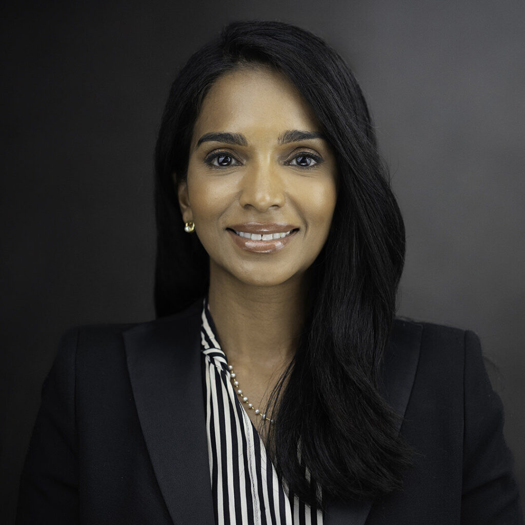 Professional real estate headshot of a confident woman in a black blazer photographed in a Northern New Jersey studio by Alex Kaplan