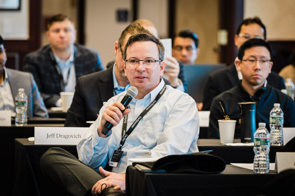 Corporate retreat session photographed from the back of the room showing full team engagement in New Jersey