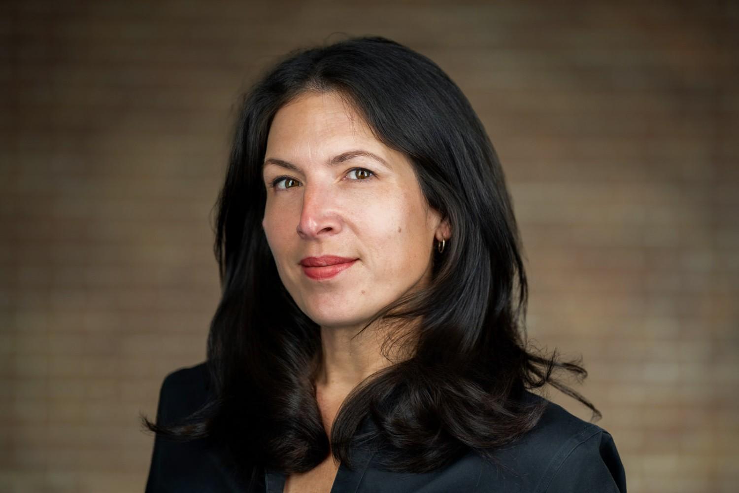 Professional corporate headshot of woman in dark blazer for NJ financial services firm