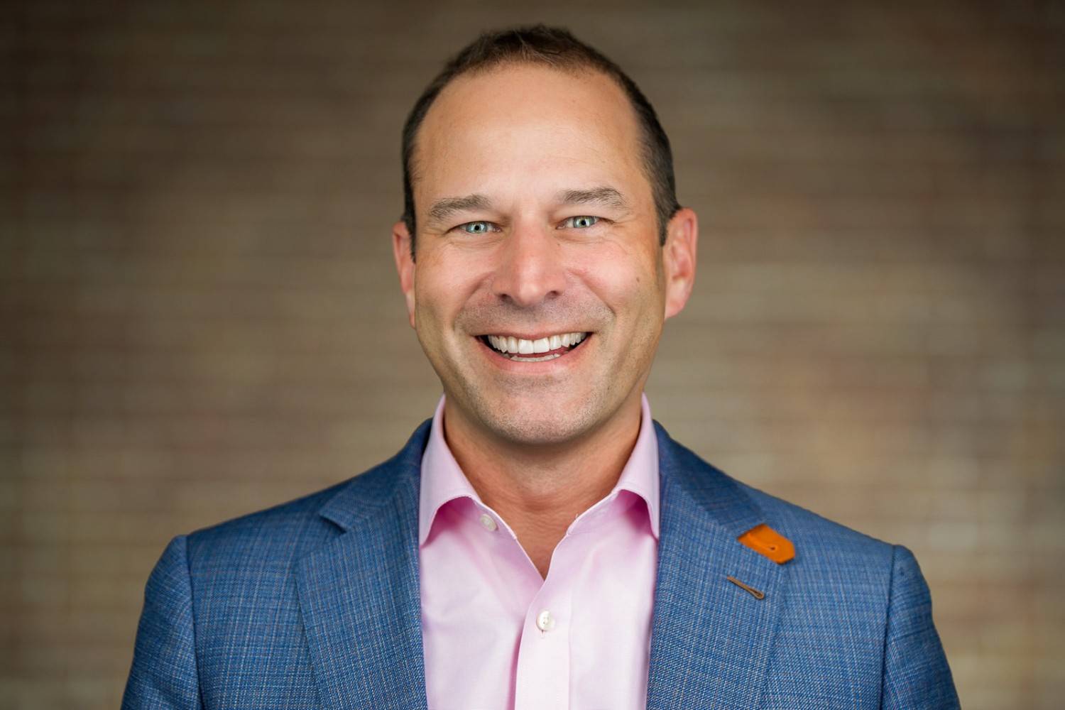 Professional corporate headshot of woman in dark blazer for NJ financial services firm