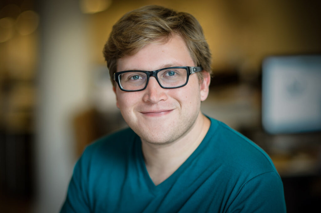 Business headshot example man in teal shirt with black glasses casual professional NJ