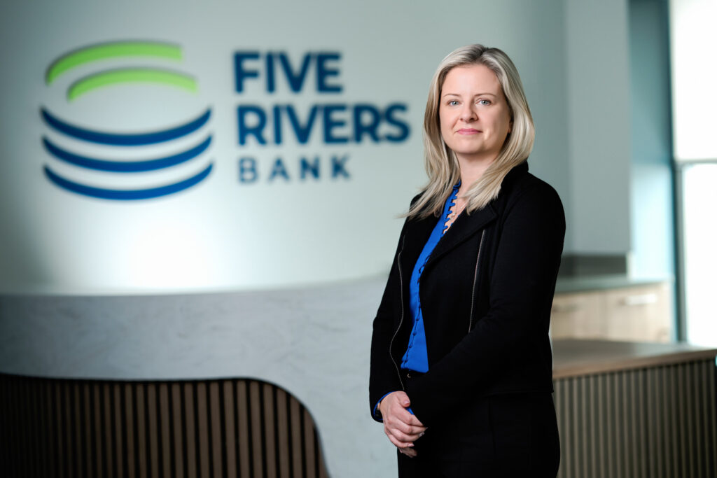Professional headshot of woman in blue blouse and black blazer at Five Rivers Bank