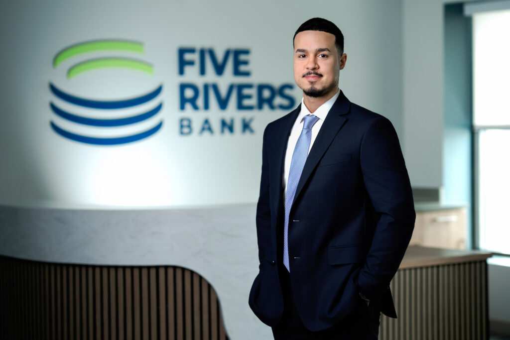 Young professional corporate headshot with light blue tie in Five Rivers Bank lobby
