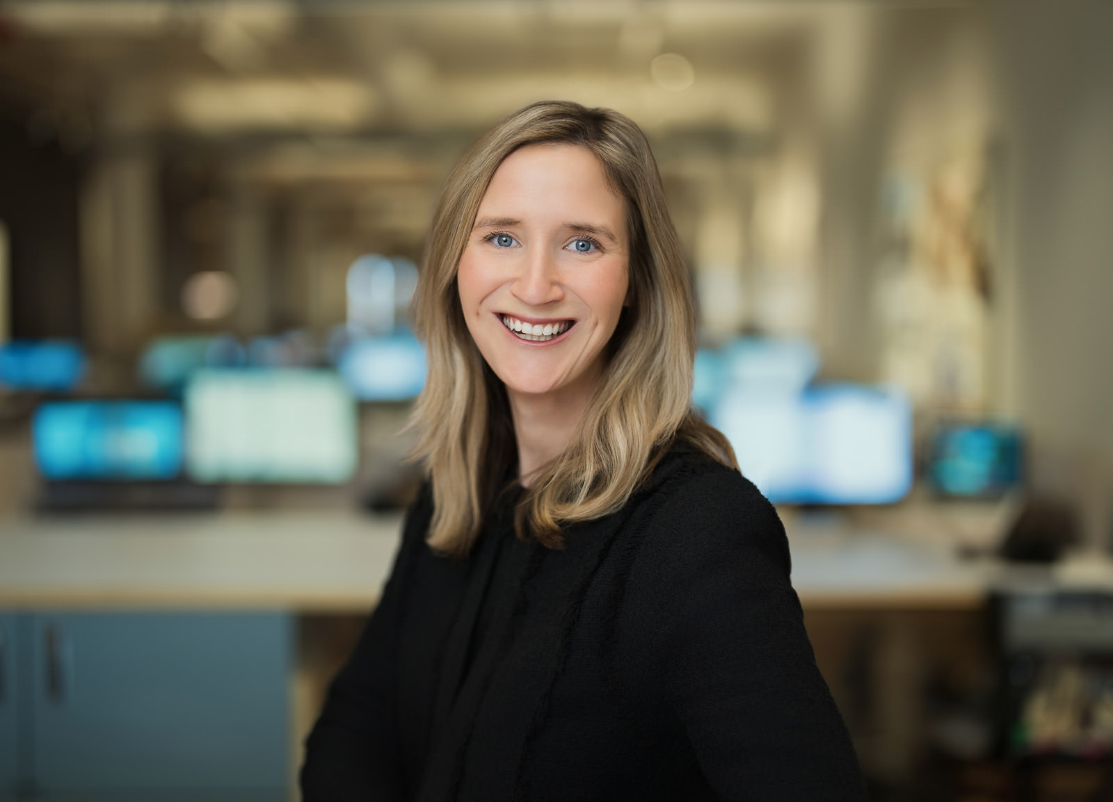 corporate headshots nyc woman blonde black blazer tech office environment