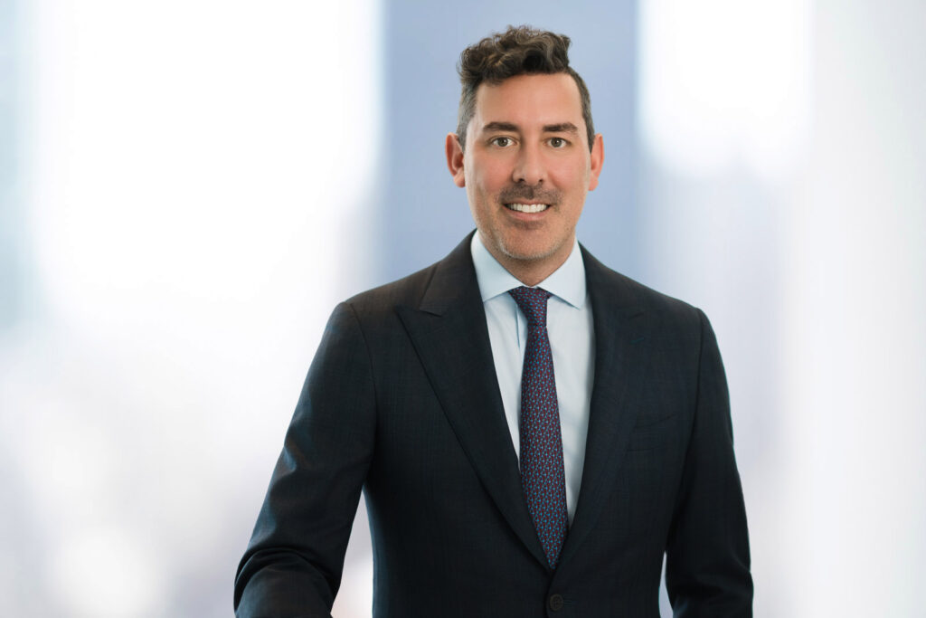 Male financial advisor headshot in dark suit and patterned tie with confident expression in New Jersey