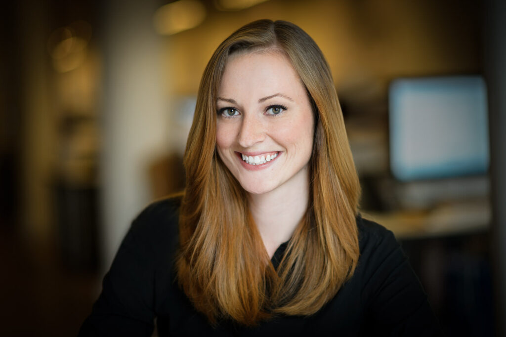 Good professional headshot example woman auburn hair bright open smile black top NJ