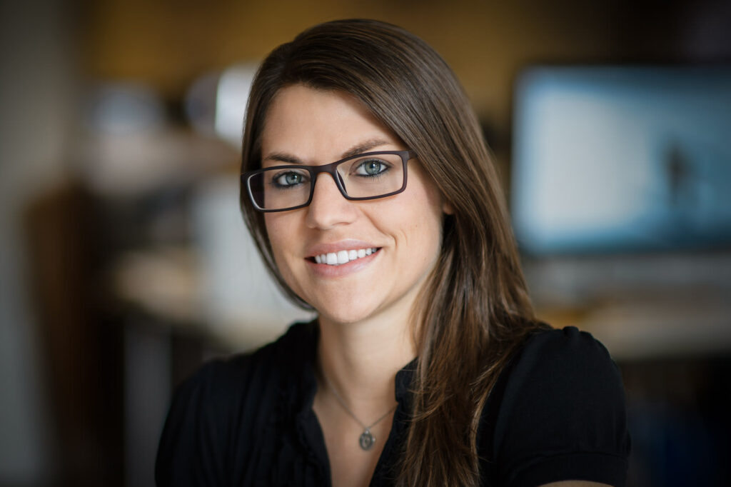 LinkedIn headshot example woman with dark frame glasses black top confident NJ