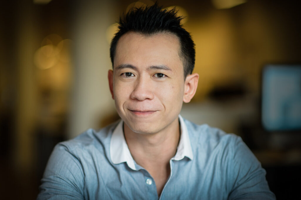 Professional headshot example approachable man in light blue shirt spiky hair NJ