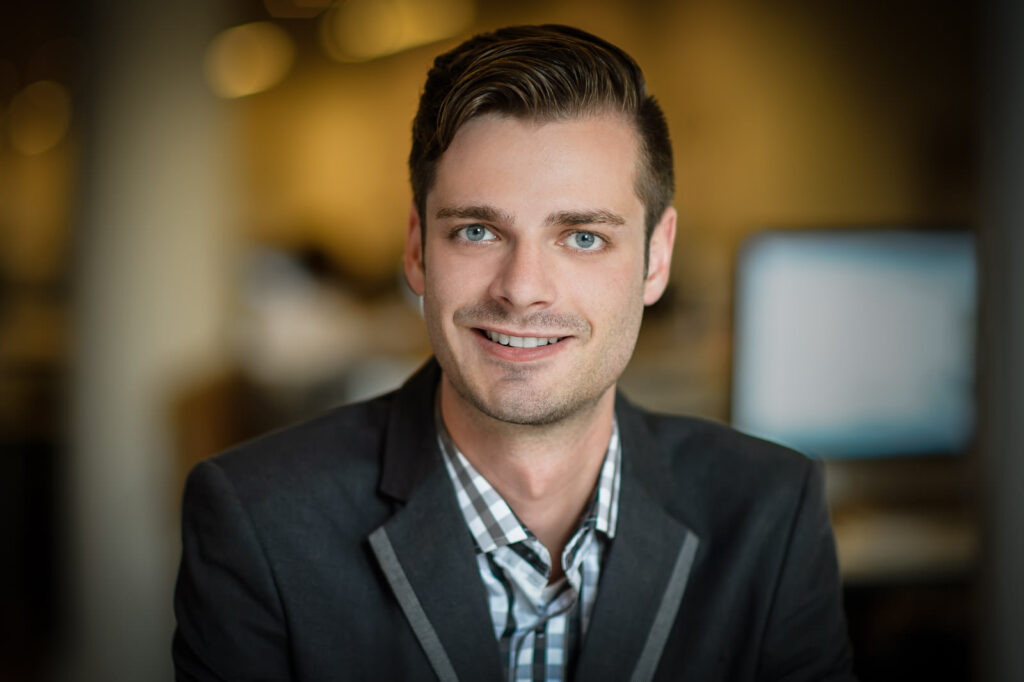 Professional headshot example young professional in grey blazer and checkered shirt NJ