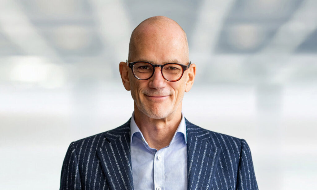 Studio executive headshot of confident business professional wearing glasses photographed in Northern New Jersey
