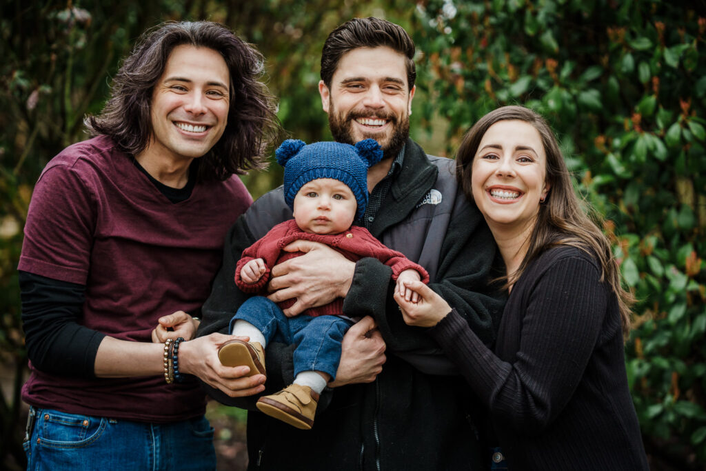 Three generation family portrait with parents grandparents and baby at Knight Park in Collingswood New Jersey