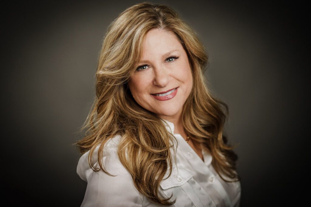 Approachable and confident LinkedIn headshot of a woman with warm expression and natural smile, photographed by Alex Kaplan in Northern New Jersey