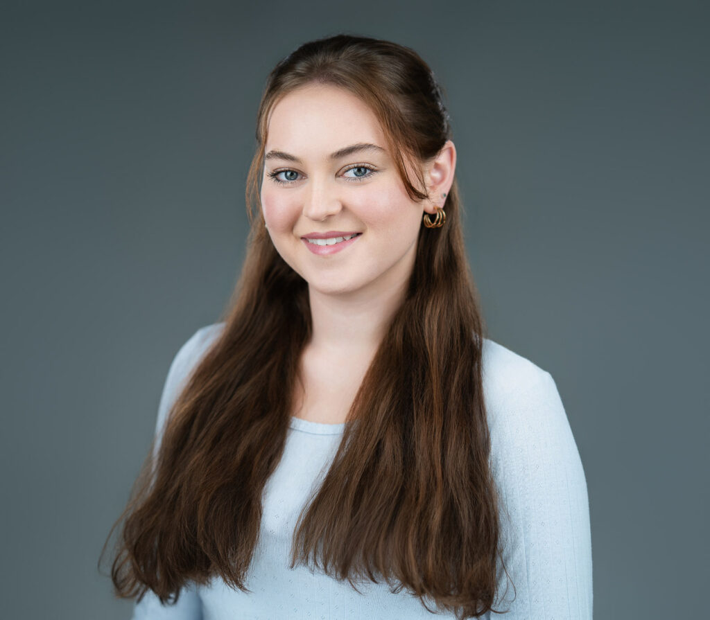 Commercial-style actor headshot with approachable smile for casting versatility