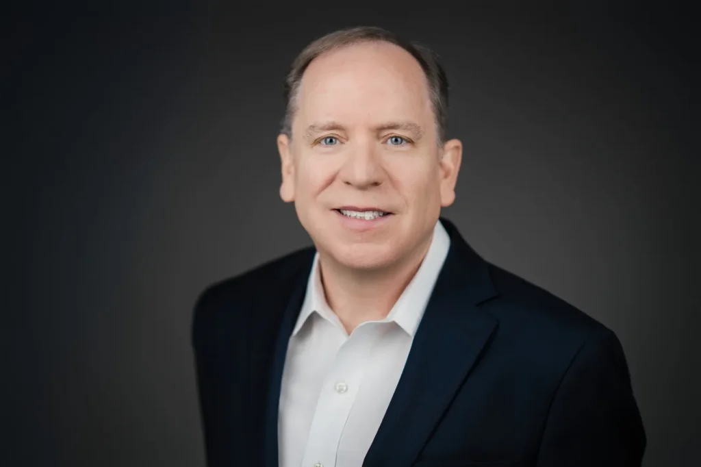 Professional executive headshot on a dark background for Northern New Jersey and NYC