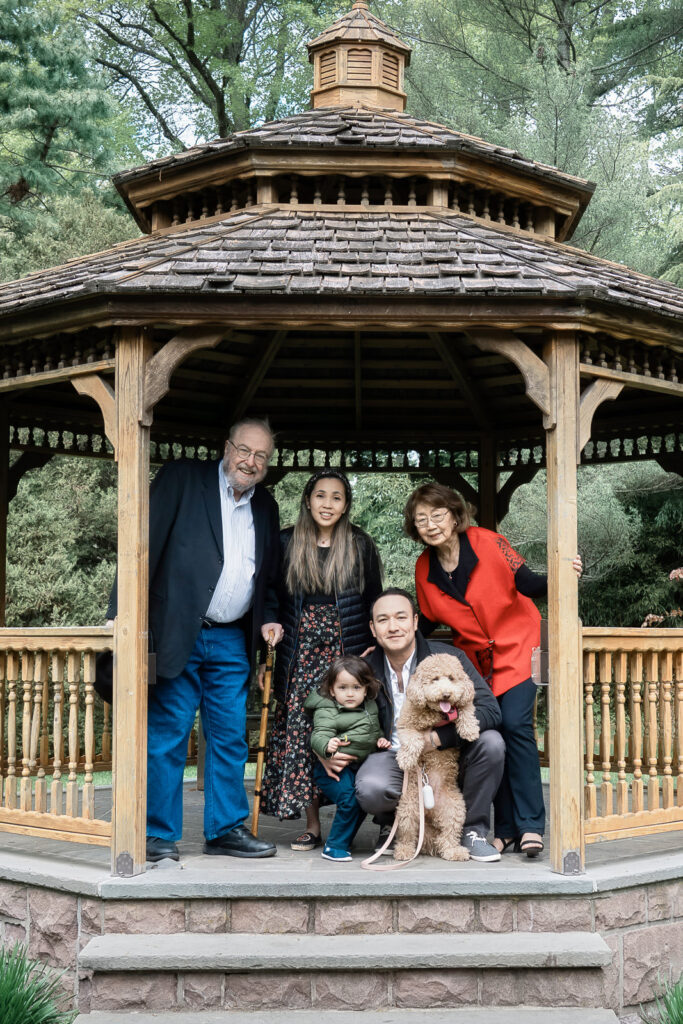 Extended family photo session at Davis Johnson Park gazebo grandparents parents toddler and golden doodle