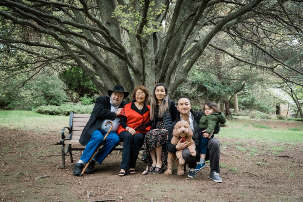 Generational family portrait on park bench under large tree Davis Johnson Park Tenafly New Jersey