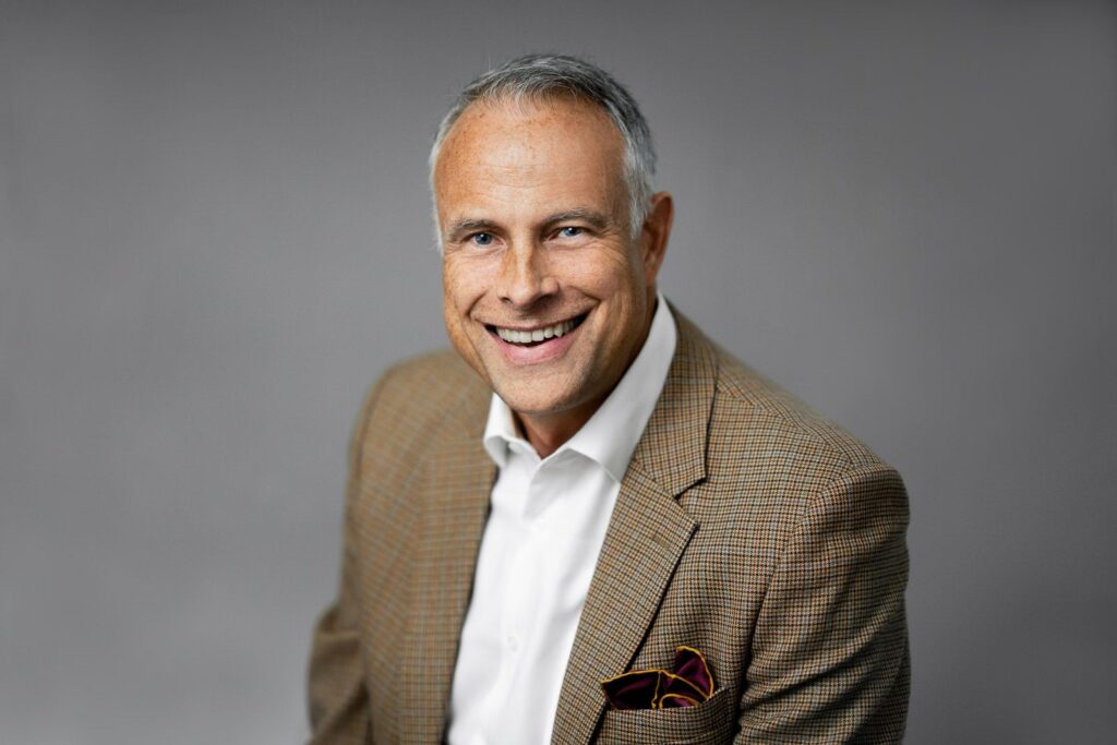 Professional man with relaxed natural expression and genuine smile in a LinkedIn headshot photographed by Alex Kaplan in Northern New Jersey
