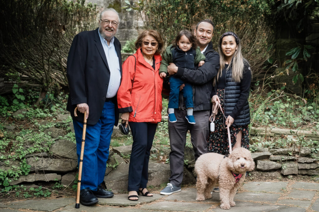 Outdoor family photography at Davis Johnson Park stone steps with three generations and golden doodle