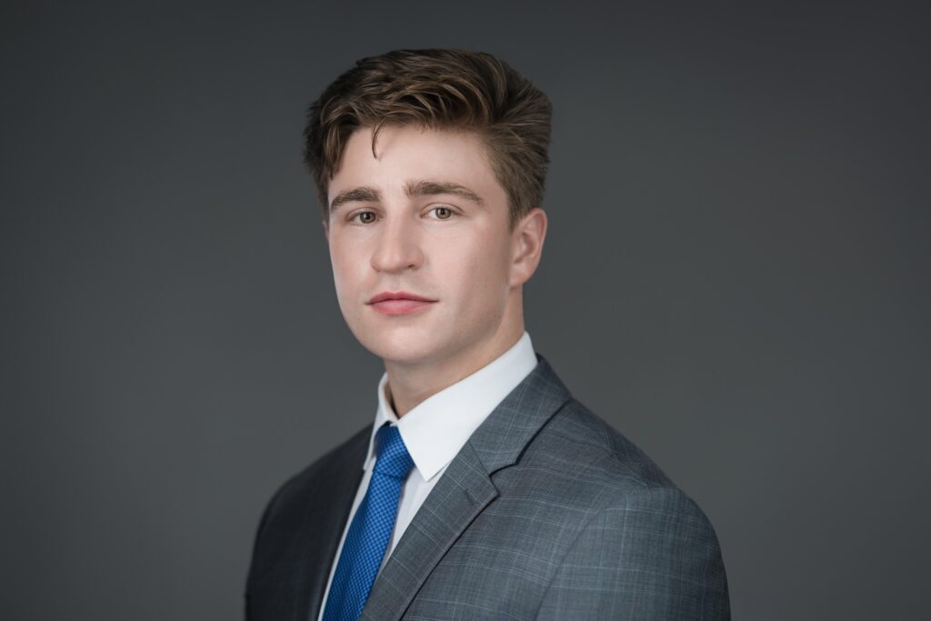 Professional headshot of a young man in a gray suit and blue tie photographed by Alex Kaplan in New Jersey