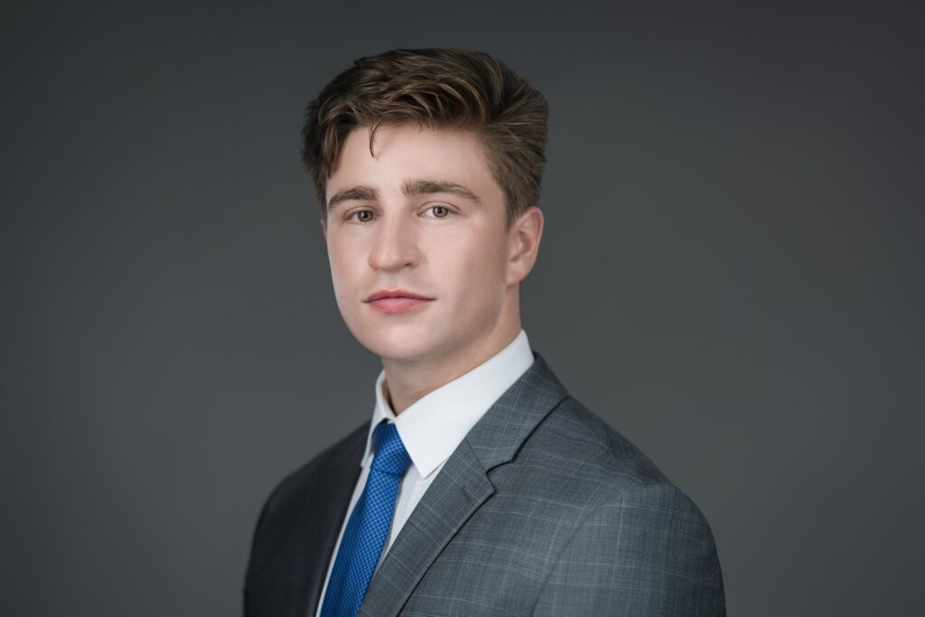 Trustworthy professional headshot of a young executive with steady, direct eye contact in New Jersey