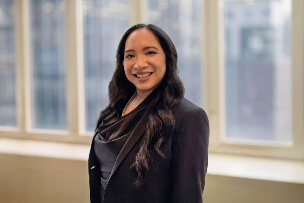Professional posing for a business portrait near office windows