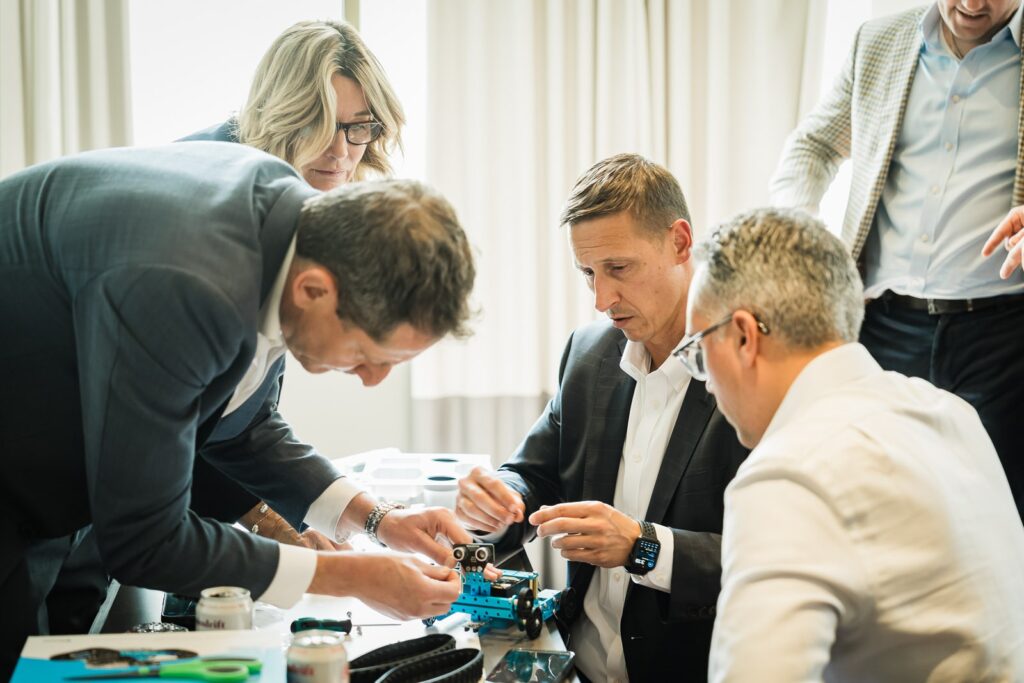 Corporate team building a robot together during a team-building exercise at MC Hotel in Montclair NJ
