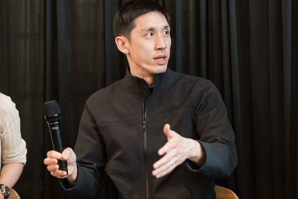 Panelist answering with a microphone during the Valon Sessions executive event