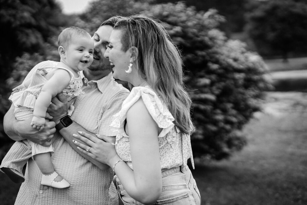 Candid family portraits with a baby showing genuine expression during a family photo session NJ