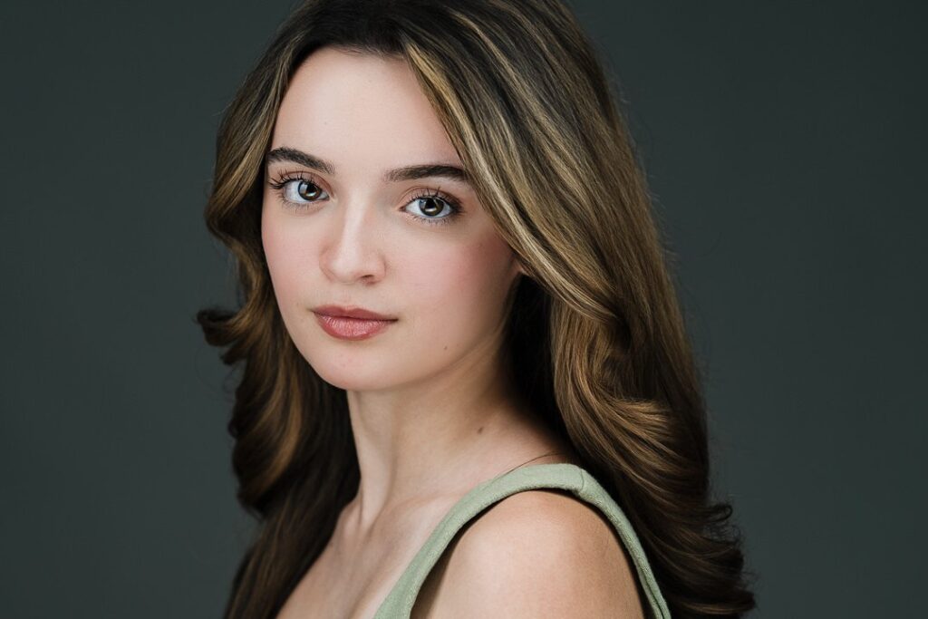 Young female model posing with a confident direct expression during a headshot session in New Milford
