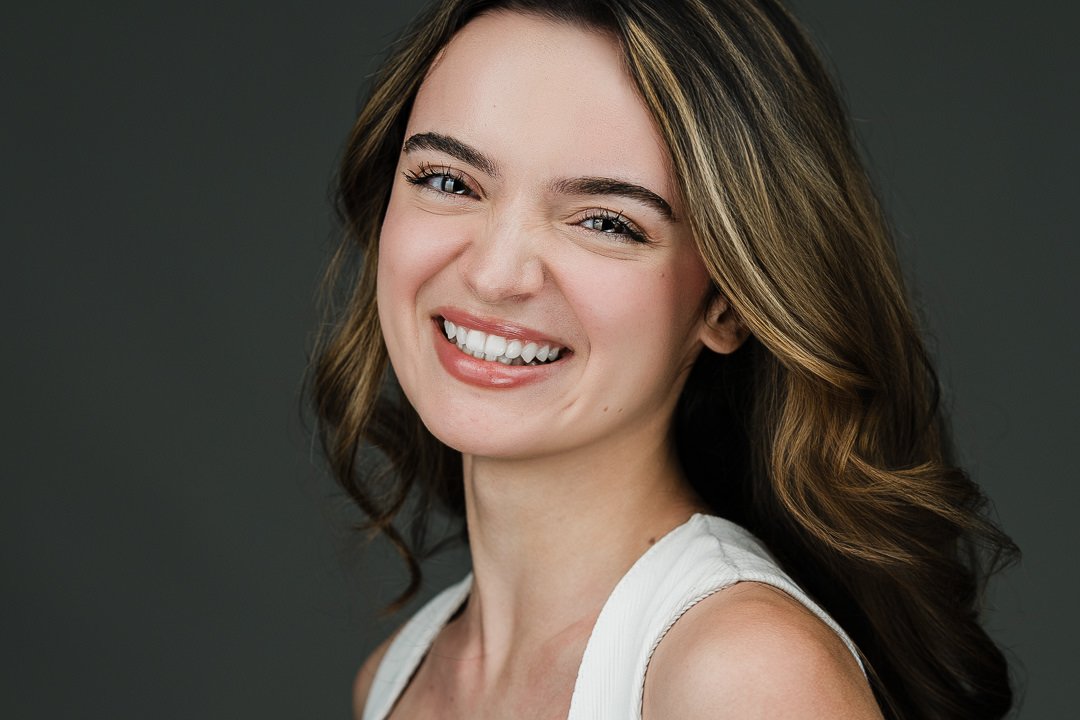 Young female model smiling naturally during a modeling headshot session in New Milford New Jersey